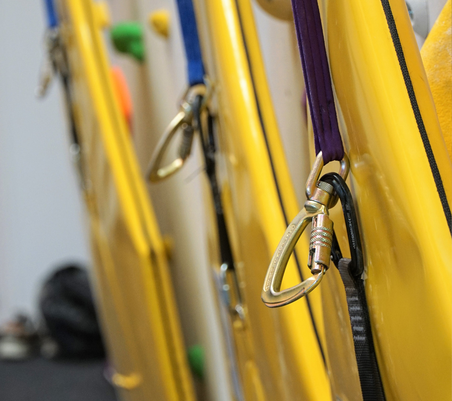A close up of auto belays carabiners and safety flags
